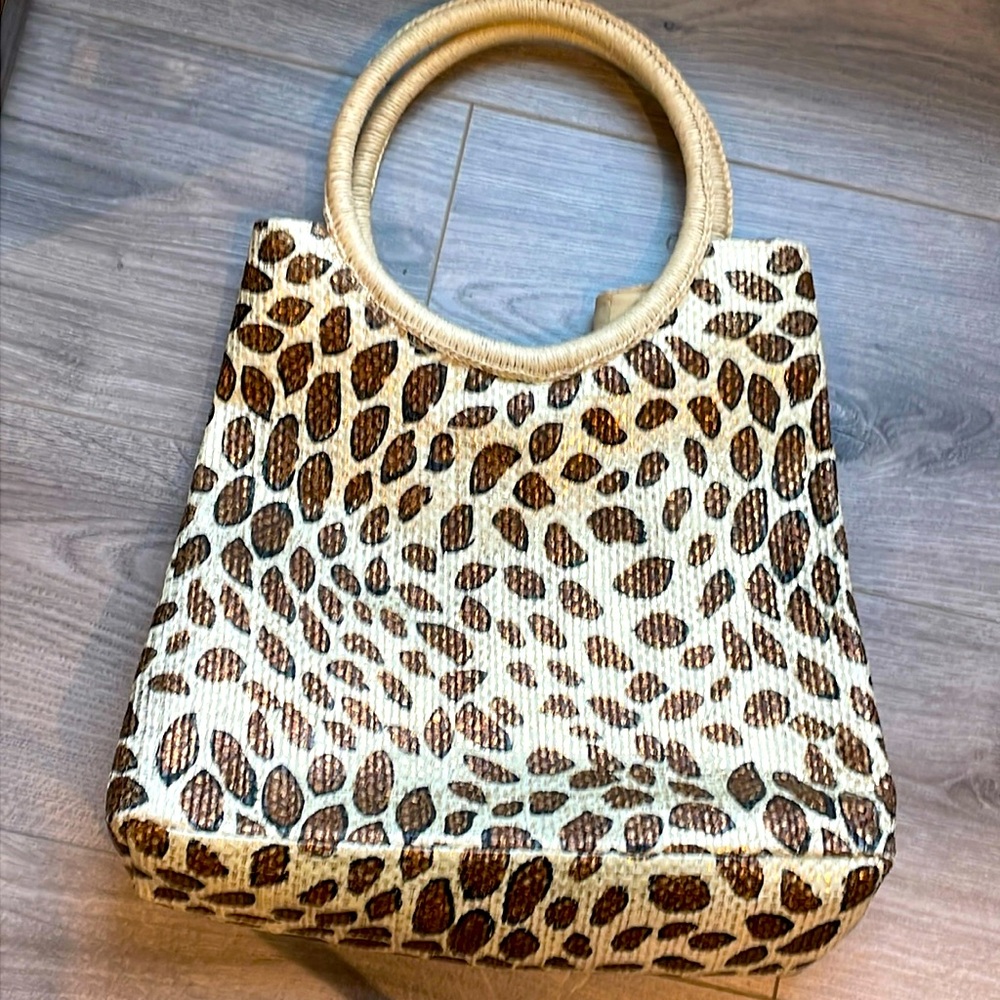 Leopard print with  hoop handles and snap closure bag.